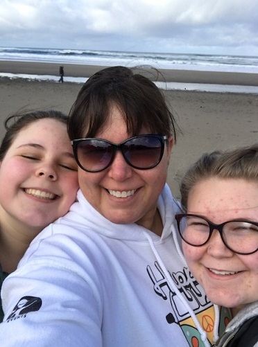 Jenn at the beach with her daughters
